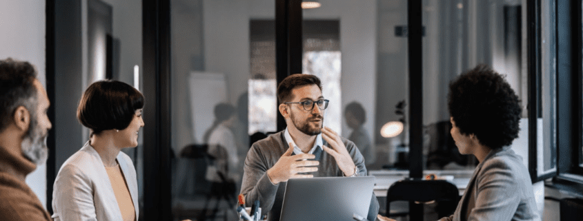 A group of professionals having a meeting in a modern office setting.